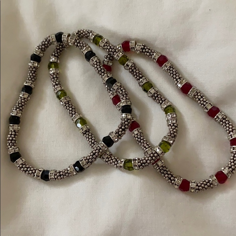 Bracelets. One red, one green, one black.